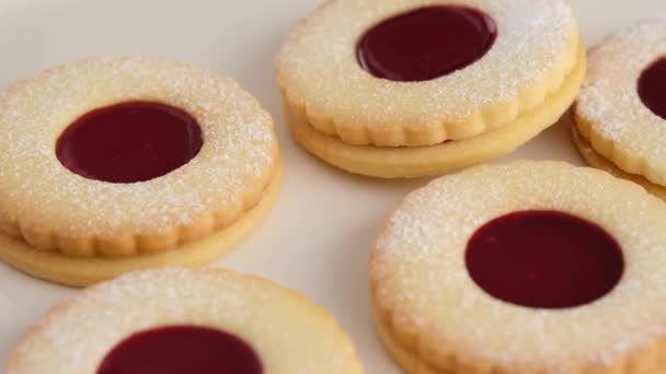 Les biscuits à la confiture sont sur la plaque. Mains féminines un biscuit maison biscuits sablés avec de la confiture. Biscuits Kurabye à la confiture de framboises. Biscuits de Noël avec confiture. — Video