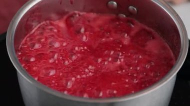 Donut doldurmak için reçel yapıyorum. Böğürtlen sosu. Kaynar kırmızı reçel. Reçel tencerede kaynıyor..
