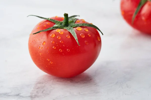 Single Juicy tomato with drops Isolated on white background.