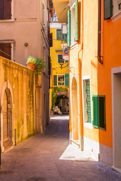 Beautiful colored hous facades in the narrow streets in Garda village, Italy