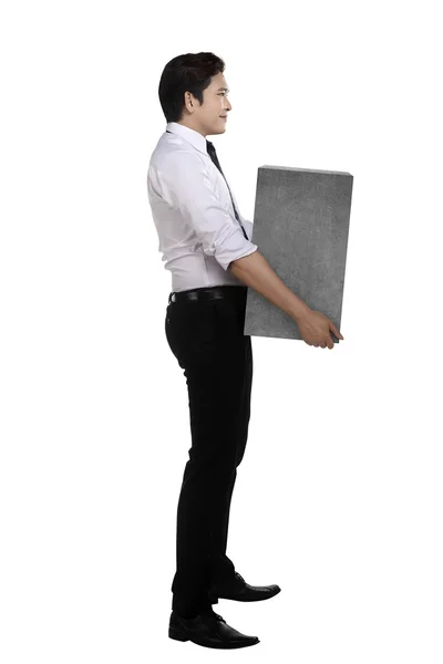 Asian businessman lift heavy box — Stock Photo, Image