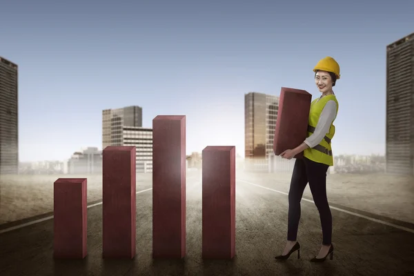 Asiatico businesswoman lifting blocco di grafico — Foto Stock