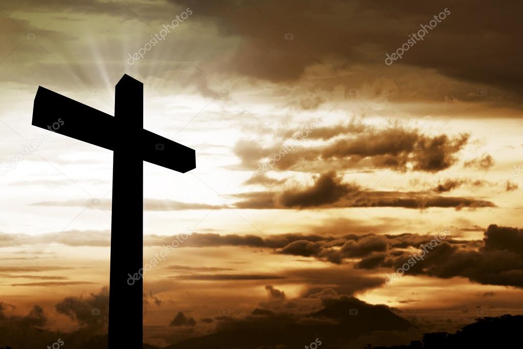 Wooden christian cross at sunset