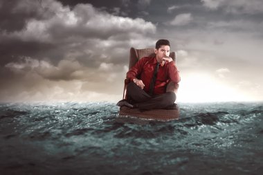 Businessman sitting on an armchair in the middle of the sea clipart