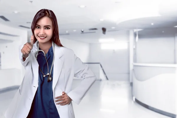 Asian doctor smiling with hospital background — Stock Photo, Image