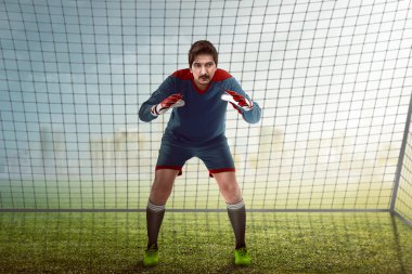 Goalkeeper in front of goalpost clipart