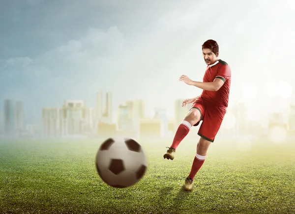 Asian football player kick ball — Stock Photo, Image