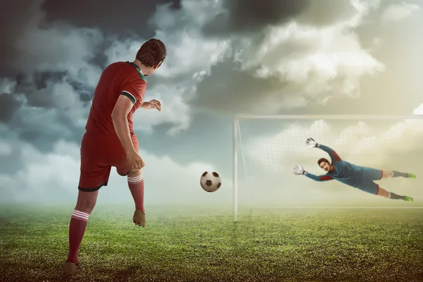 Man kicking ball on the goalkeeper — Stock Photo, Image