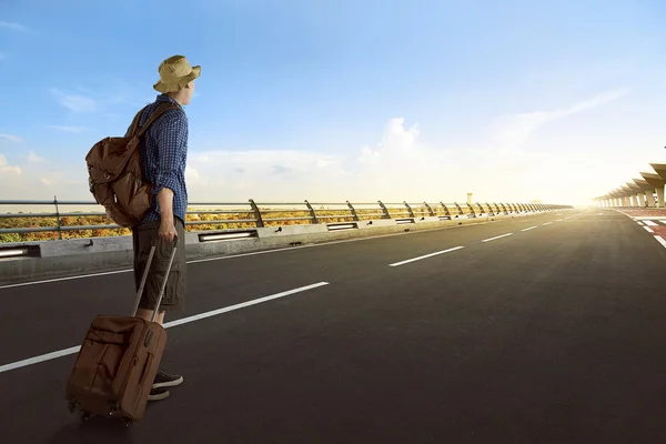 Young asian man with suitcase — Stock Photo, Image