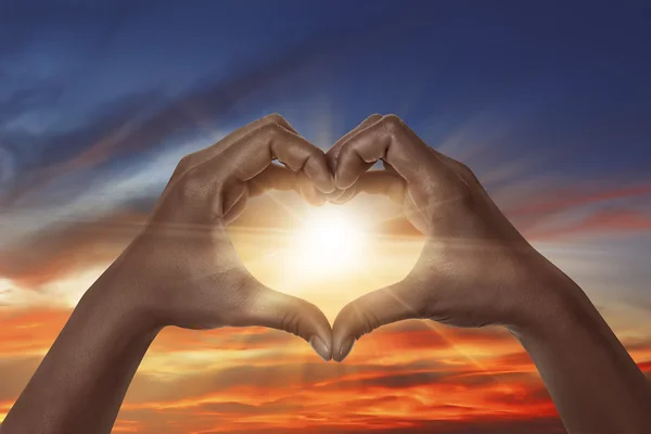 Heart shaped hands with sunset — Stock Photo, Image