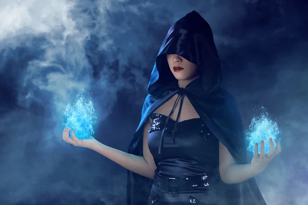 Witch woman with blue fire on her hands — Stock Photo, Image