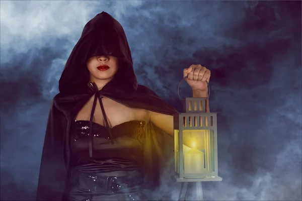 Halloween witch woman holding lantern — Stock Photo, Image