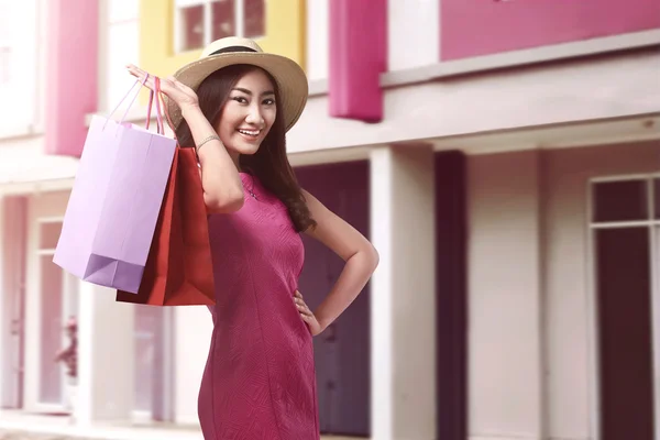 Lachende Aziatische vrouw met shopping tassen — Stockfoto