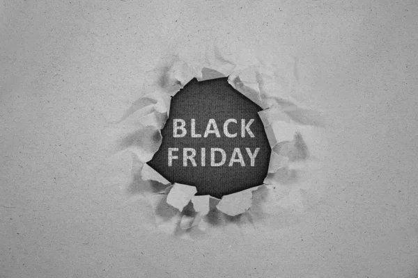 Ripped paper with Black Friday text on black background