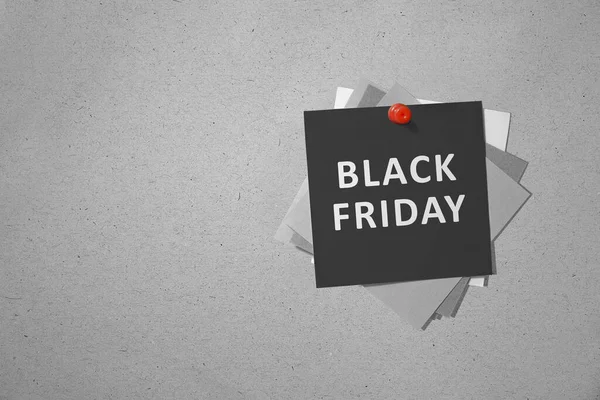 Stack of the paper with Black Friday text hanging on the wall. Black Friday concept