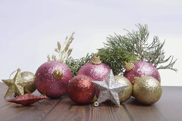 Christmas decorations with colorful ornaments on wooden table isolated over white background