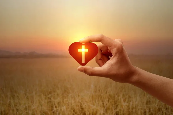 Human Hand Holding Red Heart Christian Cross Sunrise Sky Background — Stock Photo, Image