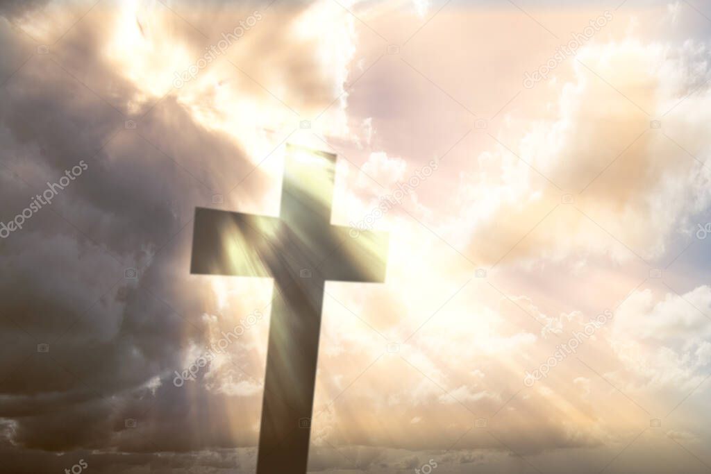 Christian Cross with sunlight and dramatic sky background