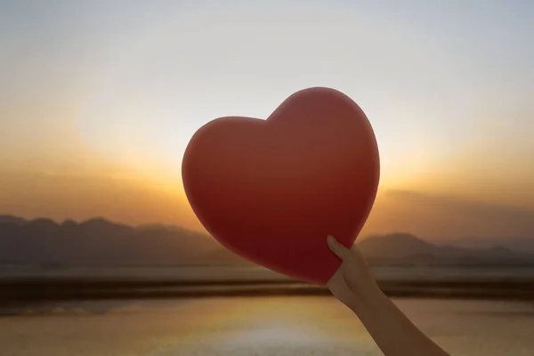 Hand Holding Red Hearts Sunset Sky Background Valentines Day — Stock Photo, Image