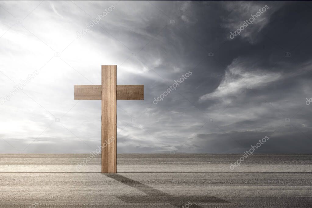 Christian cross on the wooden table with a dramatic sky background