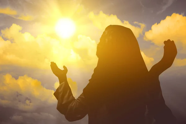 Jesus Christ praying to god with sunlight background