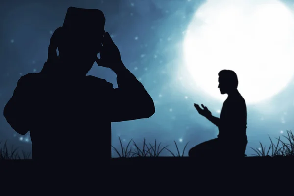 Silhouette of Muslim people praying with the night scene background