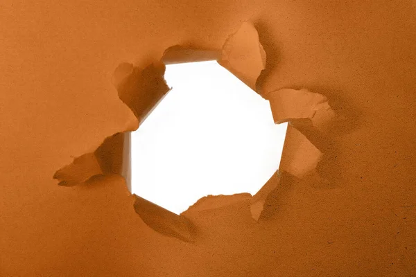 Paper with a hole torn in the middle with white background