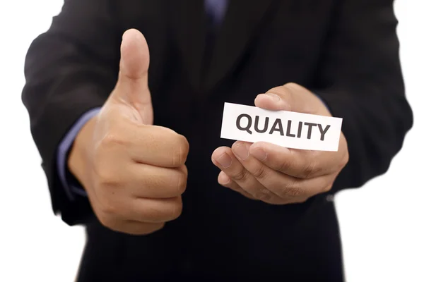 Man Holding Paper With Quality Text — Stock Photo, Image