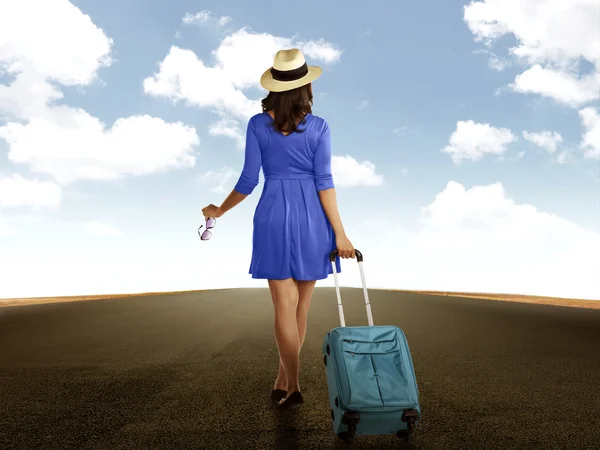 Nő a gazdaság bőrönd sétál az úton — Stock Fotó
