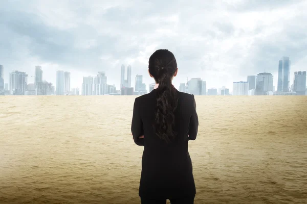 Asiática mulher de negócios olhando a cidade no deserto — Fotografia de Stock