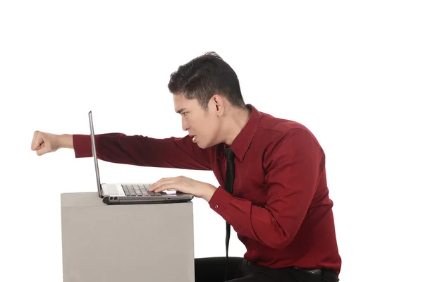 Angry business man punch laptop — Stock Photo, Image