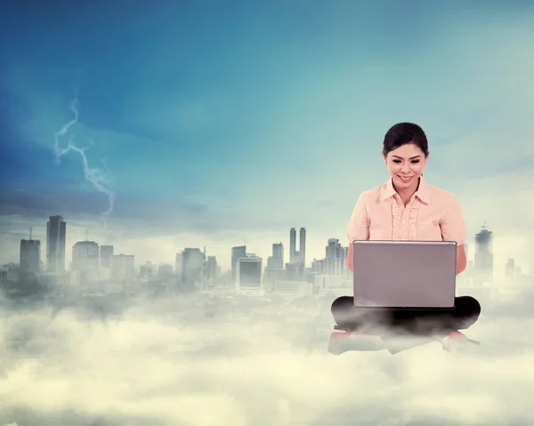 Business woman working on the cloud above the city — Stock Photo, Image