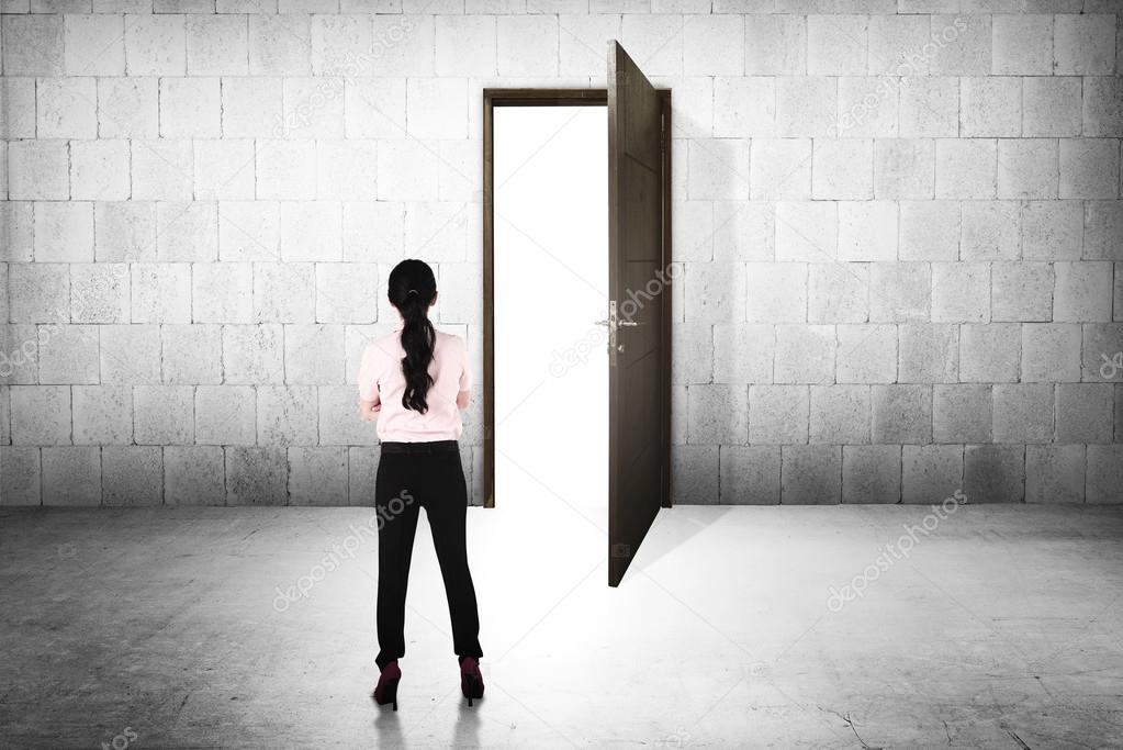 Business woman going to the open door