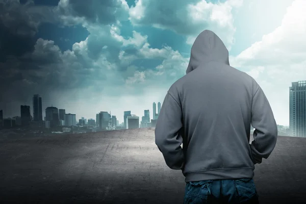 Faceless man in hood on the rooftop — Stock Photo, Image