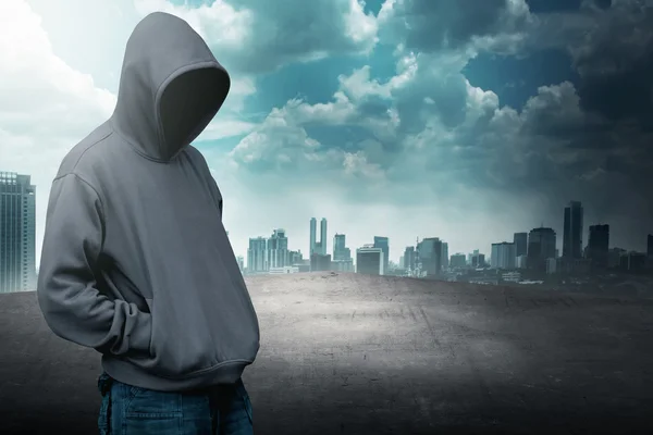 Faceless man in hood on the rooftop — Stock Photo, Image