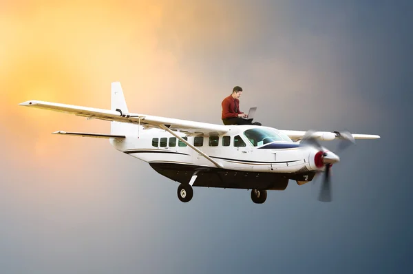 Business man sit on the top of airplane — Stock Photo, Image