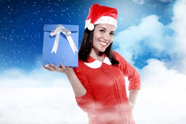 Asian woman in santa hat holding gift — Stock Photo, Image