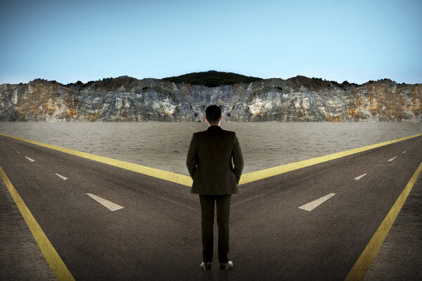 Asian man standing in the middle of cross road