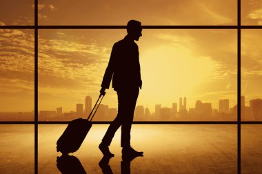 Silhouette of business man walking with suitcase clipart