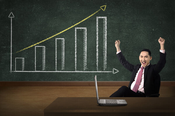 Business person smile over increasing graph