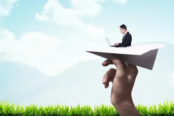 Business man typing with laptop on the paper plane — Stock Photo, Image