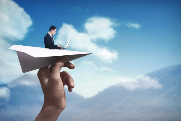 Business man typing with laptop on the paper plane — Stock Photo, Image