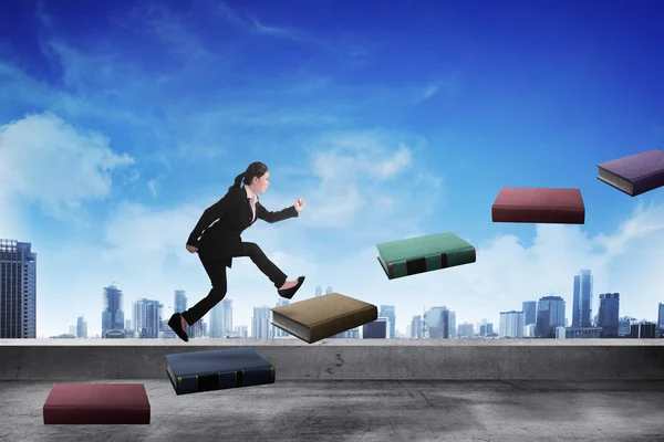 Business person step up flying book that look like stair — Stock Photo, Image