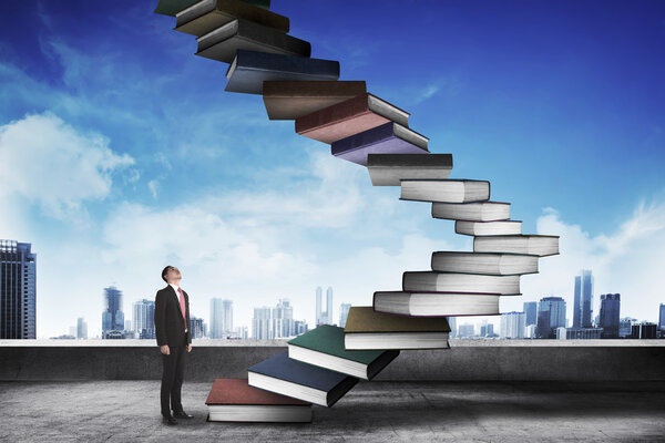 businessman step up flying books