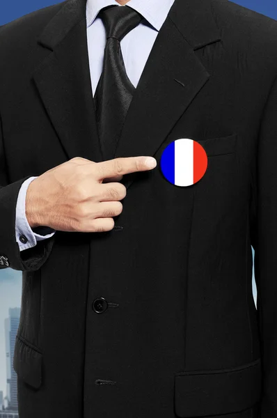 Man show pin with french flag — Stock Photo, Image