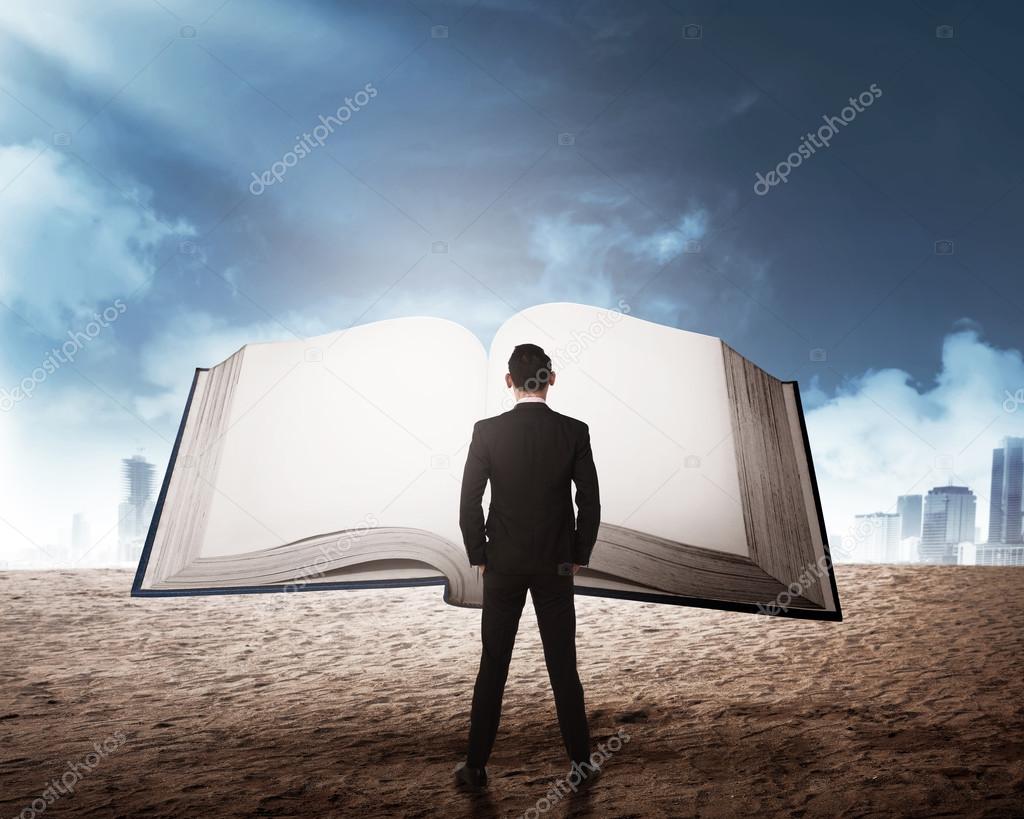Young businessman reading big book