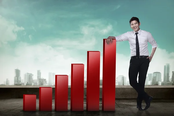 Businessman leaning on graph — Stock Photo, Image