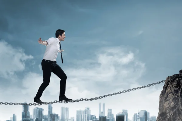 Business person balancing on the chain — Stock Photo, Image