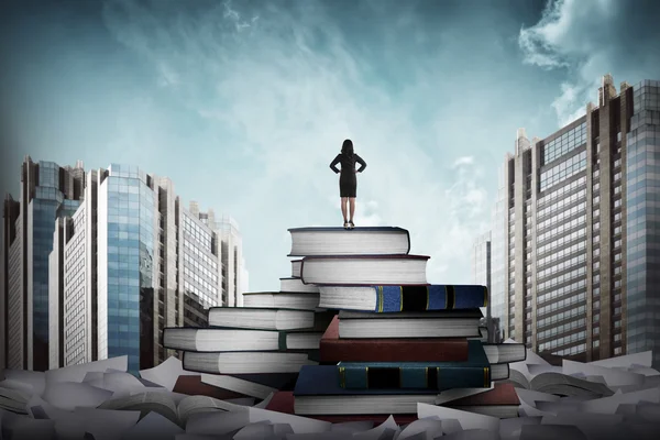 Business woman standing on the top of books — Stock Photo, Image