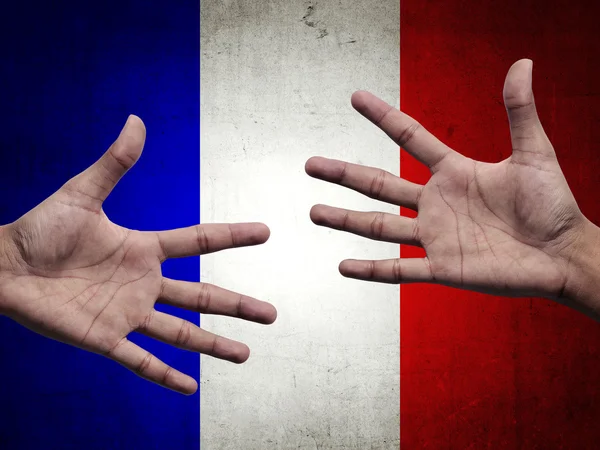 Manusia tangan di atas bendera Perancis — Stok Foto